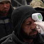 April 25, 2020, Moscow, Russia: Homeless men measure the temperature.